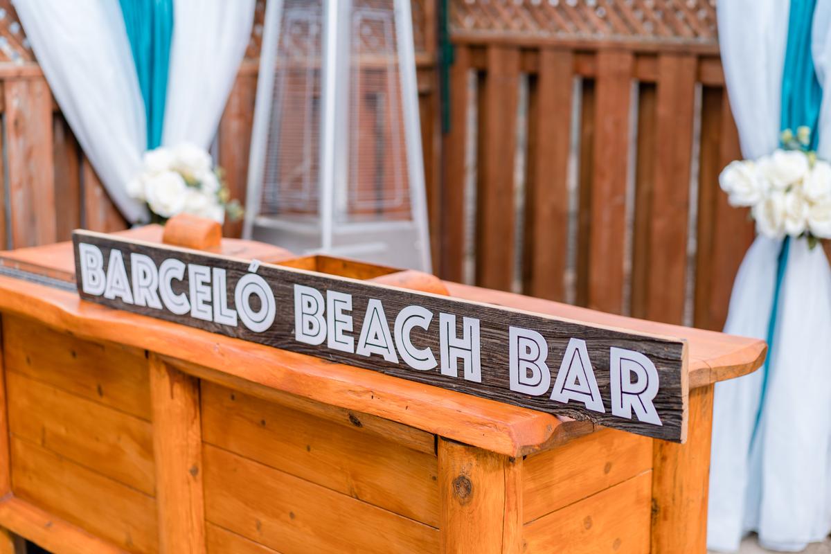 Romantic beach wedding ceremony with ocean backdrop and white fabric archway in Southern Ontario